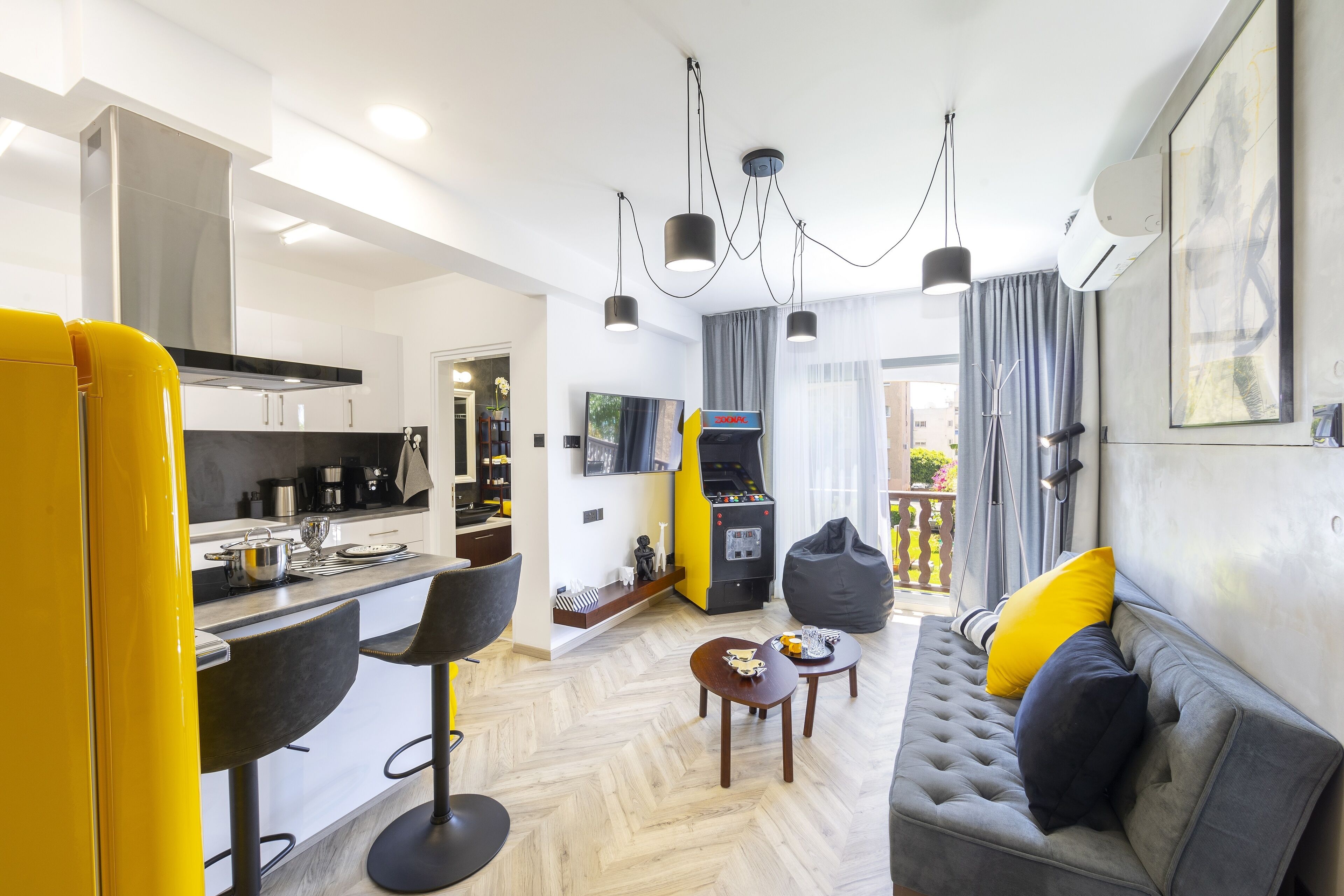 A modern living space with a kitchen, dining area, and seating area.