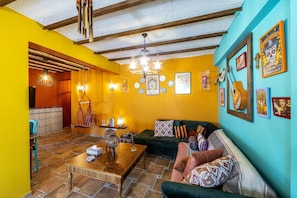 Casa Feliz Two-Bedroom Apartment (A406) | Living area | 65-inch flat-screen TV with digital channels, TV, books