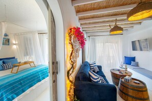 Lemnos Suite One-Bedroom Apartment (D420) | Living area | 65-inch flat-screen TV with digital channels, TV, books - Castle Holiday Apartments (Limassol)