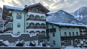 A multi-story building with balconies, a sign for 'Pichler's Restaurant', and snow-covered surroundings. - Hotel Rothirsch by Skinetworks (Sankt Johann im Pongau)