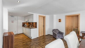Un appartement moderne comprenant une cuisine, un coin repas et un salon.