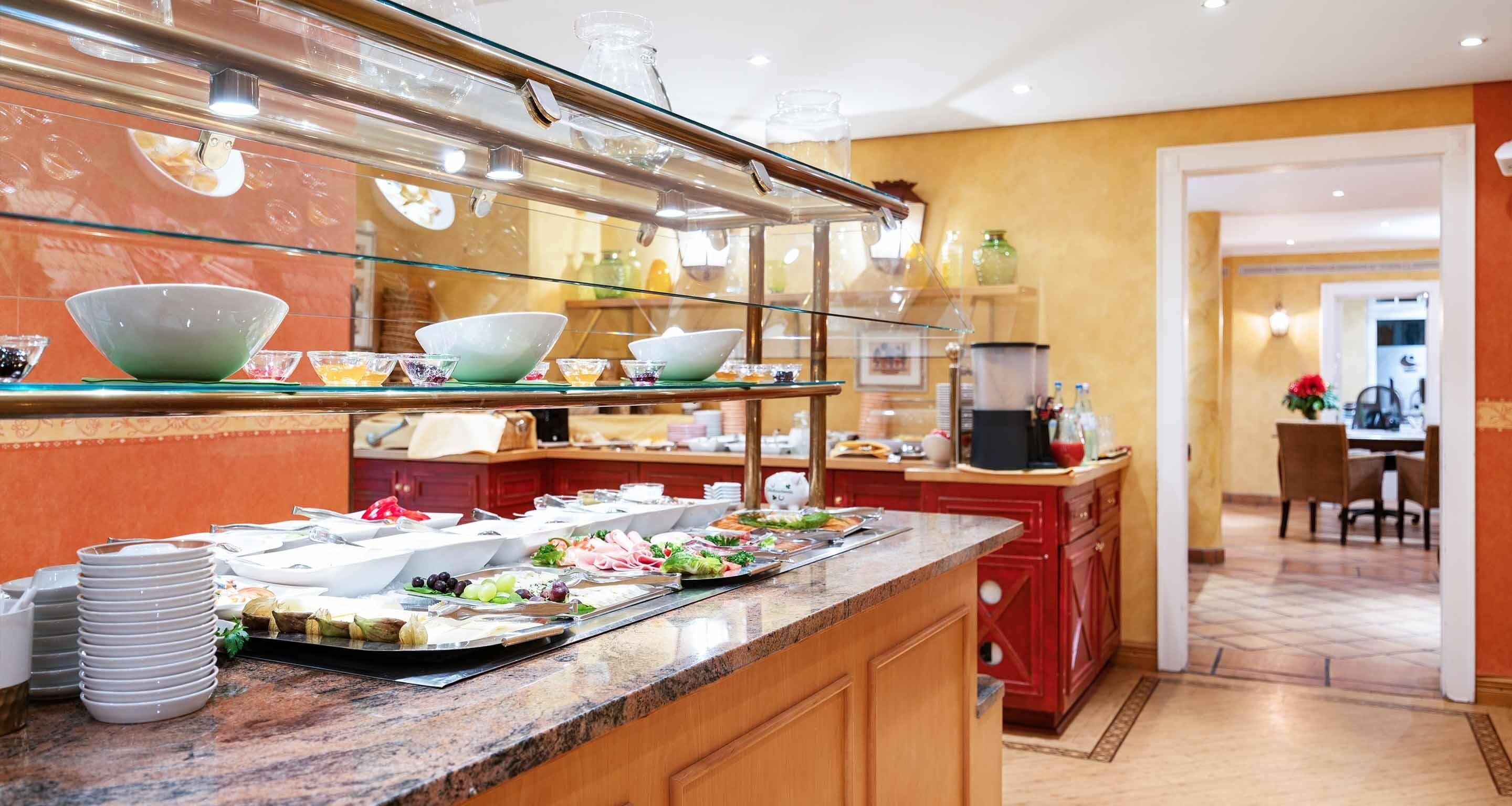 A buffet area with a variety of food items and serving dishes.