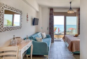 Quarto superior, vista parcial para o mar | Sala de estar | Smart TV