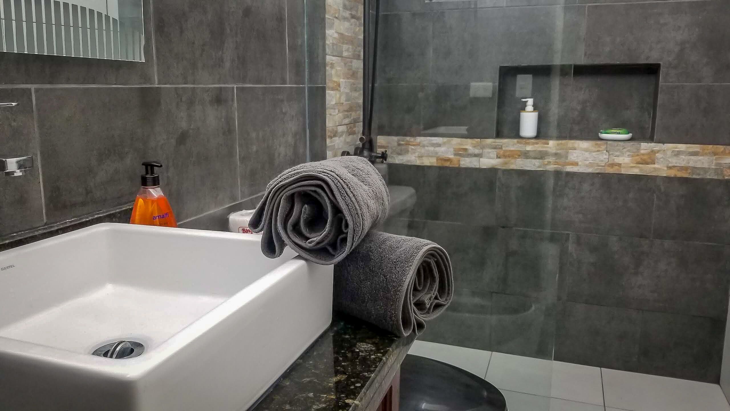 Shower, rainfall showerhead, hair dryer, towels