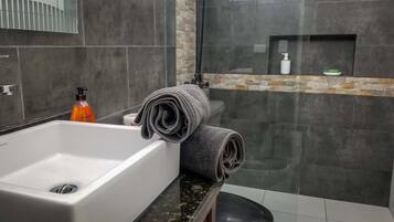 Shower, rainfall showerhead, hair dryer, towels