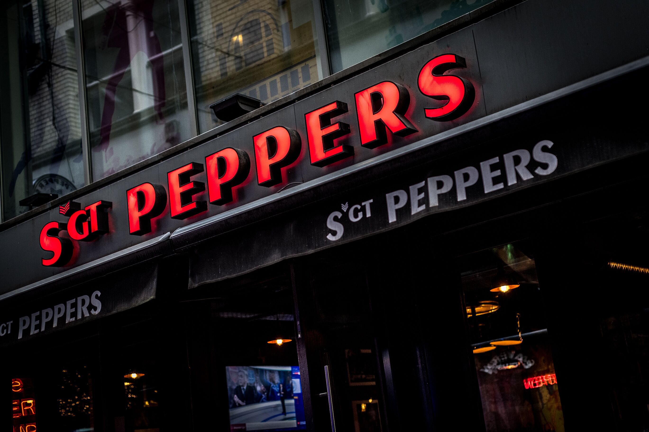 A storefront with the sign "SGT PEPPERS" in red and white letters.