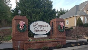A brick entrance with a sign reading "Reagan's Landing" and a wreath on each side.
