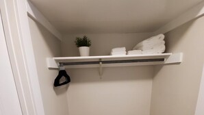 A small, enclosed closet with a wooden floor, white walls, and a white door. - Modern Condo only Minutes from Deadwood & Sturgis! (Lead)