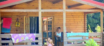 Wooden Cottage With a Veranda Located in a Natural Area