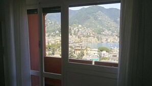 A room with a view of a hillside town and a body of water. - Eurotel 405 (Rapallo)