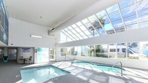 An indoor swimming pool with clear glass ceilings and a view of the outside. - Stunning OCEAN FRONT Large 2 bedroom SUITE with breathtaking views (Murrells Inlet)