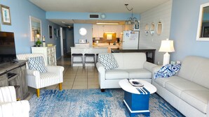 A living room with a sofa, chairs, a coffee table, and a rug. - Stunning OCEAN FRONT Large 2 bedroom SUITE with breathtaking views (Murrells Inlet)