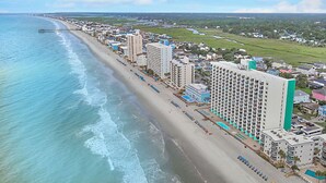 A coastal hotel with multiple high-rise buildings, a beachfront, and a pool area. - Stunning OCEAN FRONT Large 2 bedroom SUITE with breathtaking views (Murrells Inlet)