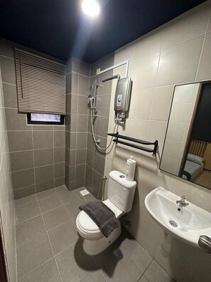 A modern bathroom with a toilet, shower, and sink. - Tatami D'Tepi Laut Pangkor (Pangkor Island)