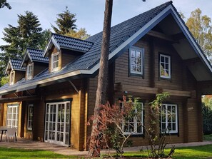 Stroll through the charming front porch and enter a cozy home with large windows and a beautiful garden.