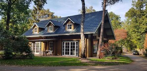 Enjoy outdoor dining or relaxation on the front porch of this charming home, surrounded by mature trees.
