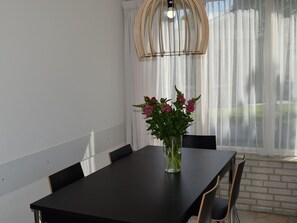 Enjoy meals in this dining area with a table and chairs, surrounded by a beautiful view of the outdoors.