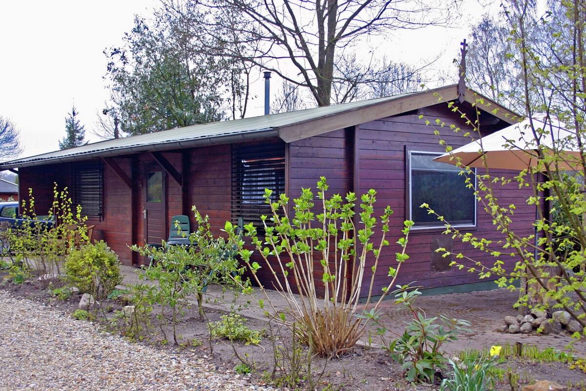 A rustic house with a sloped roof, wooden siding, and a front porch.