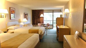 A hotel room with two beds, a desk, a chair, and a dresser. - Impala Island Inn (Ocean City)