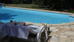 A swimming pool with lounge chairs and a glass of drink. - Quend-plage Apartment With Pool (Quend)