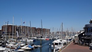 A marina filled with various boats docked along a waterfront. - Sunlit Retreat With Balcony (The Hague)