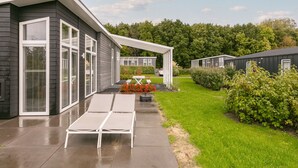 A modern building with large windows and a covered patio area. - House in Zeeland Near Oosterschelde (Wemeldinge)