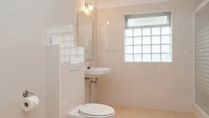 A bathroom with a toilet, sink, and a window. - Holiday Home in Bergen Near North Sea Beach (Bergen aan Zee)