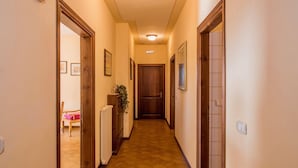 A narrow hallway with wooden doors and a radiator on the left. - Farmhouse Umbria-tuscany With Pool (Citta della Pieve)