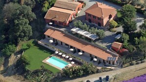 An aerial view of a property with multiple buildings, a swimming pool, and a parking area. - Farmhouse Montalto Near Sandy Beaches (Montalto di Castro)