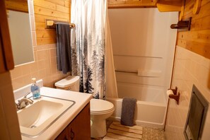 A bathroom with a sink, toilet, and bathtub. - Keepin' It Reel - Large Cabin for the Whole Family at Historic Vicker's Ranch - Sleeps 10 (Lake City)