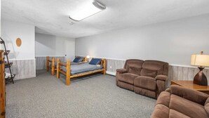 A room with a bed, two brown sofas, a lamp, and a ceiling light. - Charming 2-unit retreat in Rockford (Rockford)