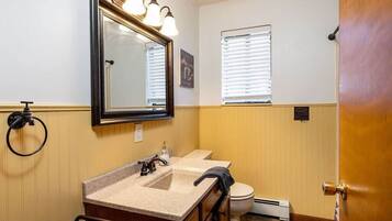 Bathtub, hair dryer, towels, shampoo