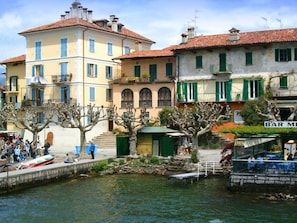 A waterfront scene with buildings, a dock, and a bar named "BAR M".