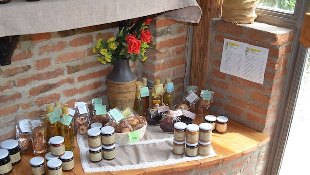 A rustic display of food items and a menu board in a brick-walled setting. - Cozy Cottage in Portomaggiore near Lake (Portomaggiore)