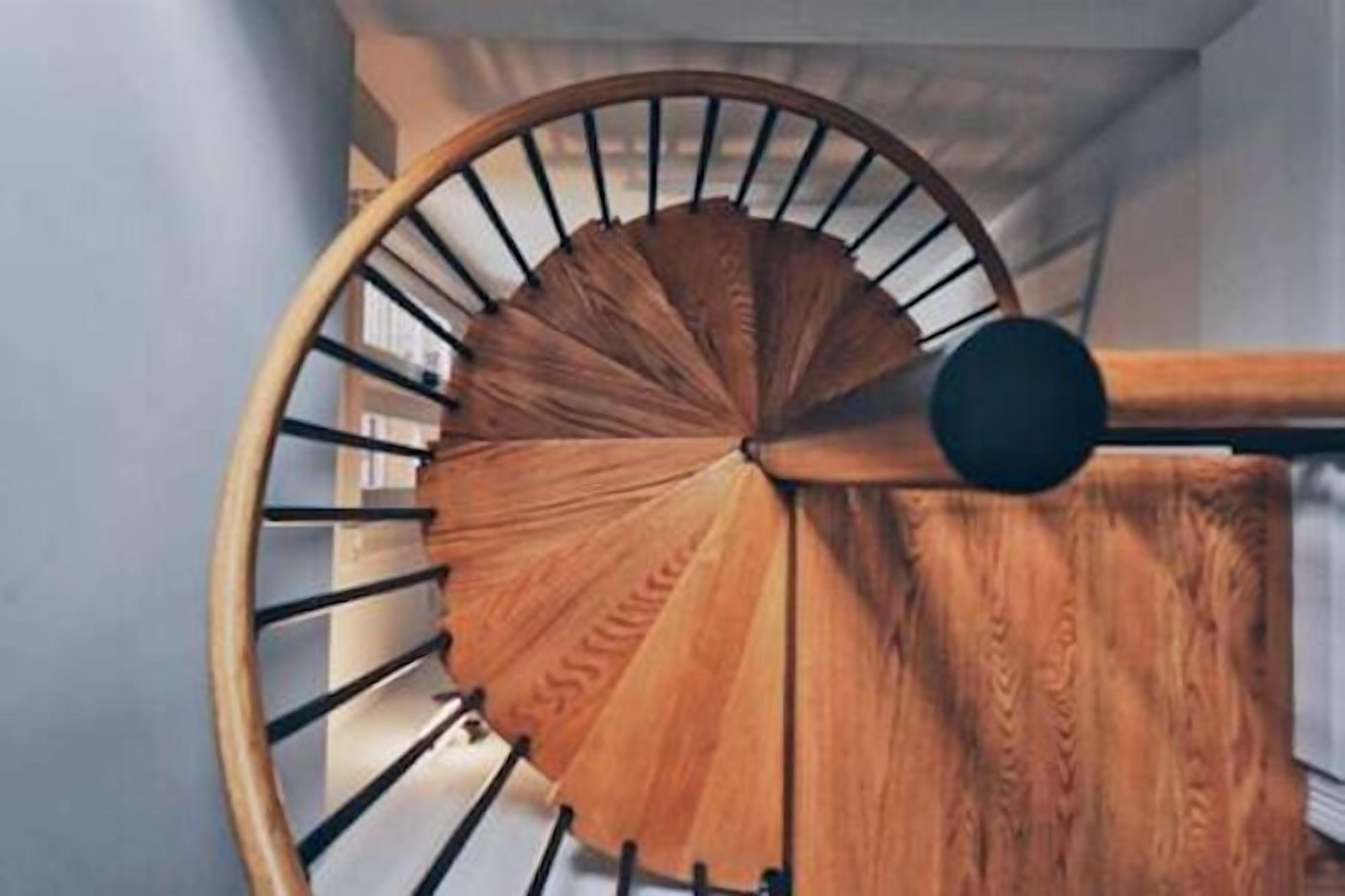 A wooden spiral staircase with a classic design.