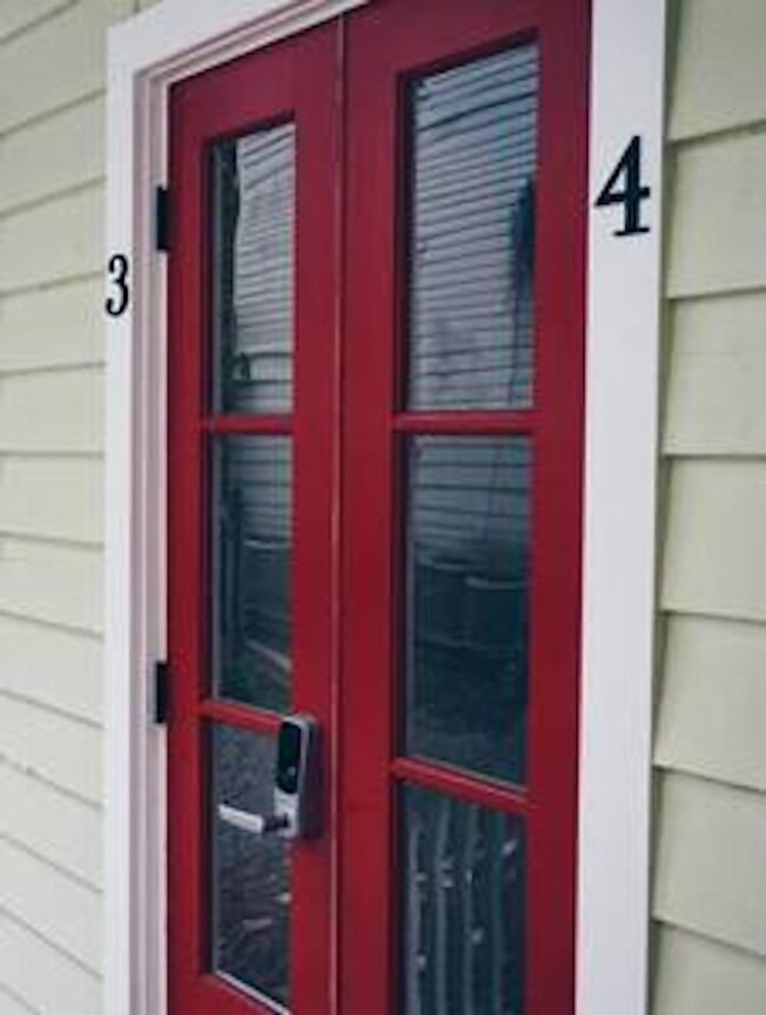 A red door with a window, marked with the number 4.