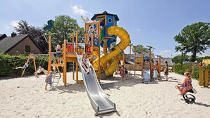 A playground with a slide, swings, and climbing structures.