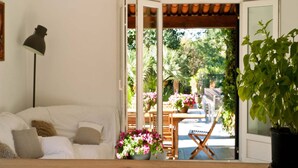 A room with a white sofa, a floor lamp, a wooden table, and a potted plant. - Holiday Home in Frejus Near Sea and Lake (Fréjus)