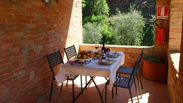 Enjoy a casual dining experience with a view of lush greenery from this outdoor seating area.