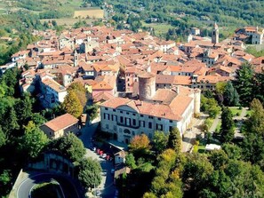 A historic town with tightly packed buildings, a prominent church, and a central square.