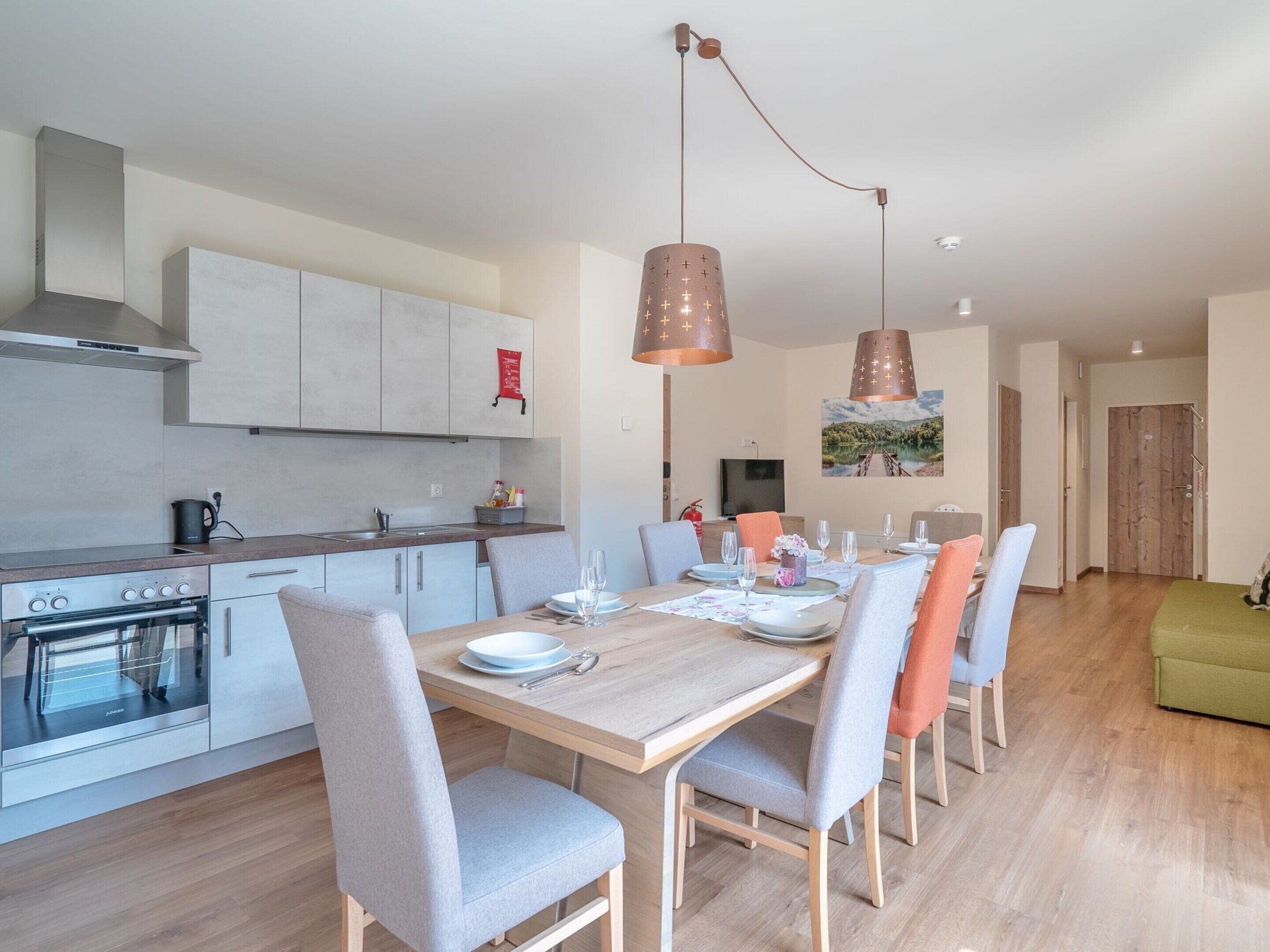 A modern kitchen with a dining area.