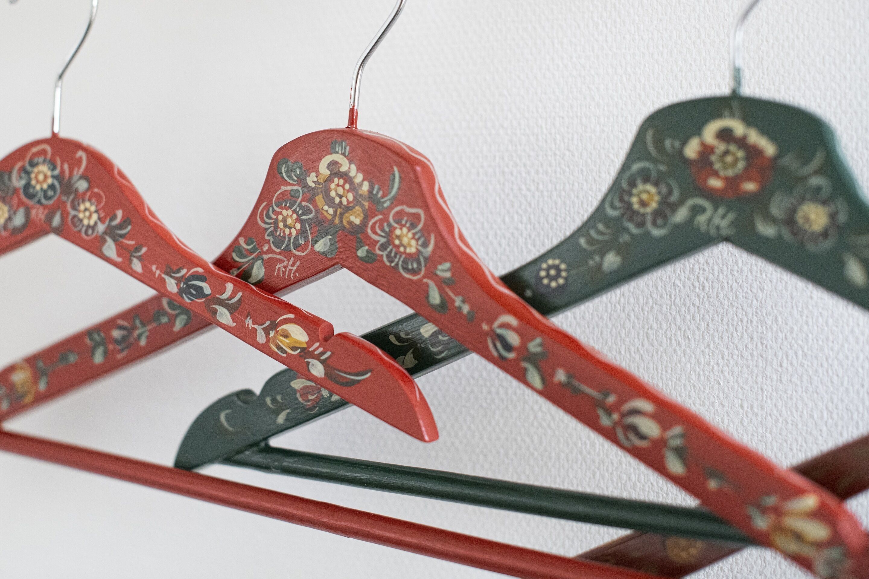 A close-up of a clothing rack with hangers featuring floral designs.