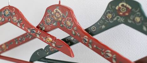 A close-up of a clothing rack with hangers featuring floral designs.