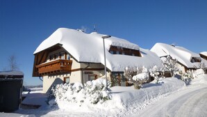 A snow-covered building with a wooden balcony and a sign indicating it is a hotel. - Lush Apartment in Furtwangen near Black Forest with Balcony (Furtwangen)