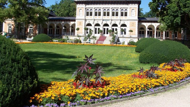 A large, historic building with a symmetrical facade, arched windows, and a central staircase leading to a balcony. - Nature & Wellness in Sohl (Bad Elster)