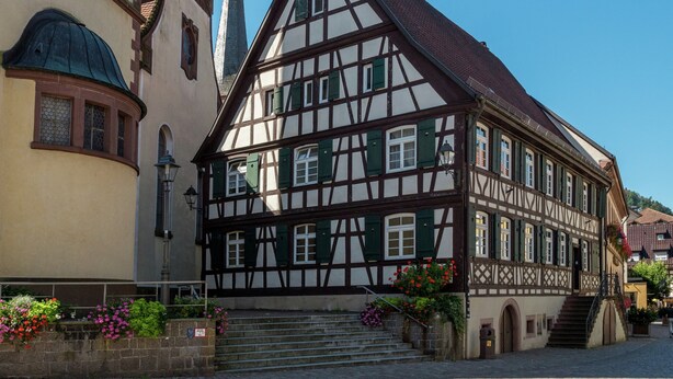 A traditional half-timbered building with a steeply pitched roof, a visible tower, and a staircase leading to the entrance. - Cheerful Apartment near Historic City Center of Haslach (Haslach im Kinzigtal)