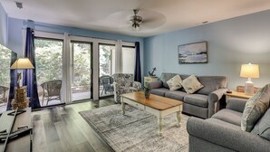 Ein Wohnzimmer mit einer Couch, einem Couchtisch und einem Gemälde an der Wand.
