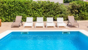 A swimming pool with four lounge chairs and a hedge in the background. - Modern Town Villa "Bona Mar" with Pool (cala ratjada)