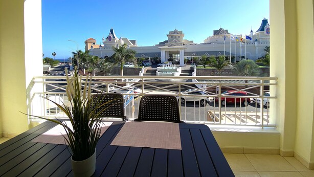 A balcony with a view of a hotel and a marina. - Ocean Golf & Country Club J&K A3 (Oasis del Sur)