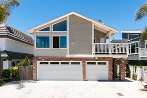 A two-story house with a balcony, a garage, and a brick facade. - 5227S -185027: 3  BR, 2  BA House in Oxnard, Sleeps 7 (Oxnard)